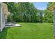 Expansive backyard featuring lush green grass and a tranquil wooded backdrop offers serenity and space at 1382 6Th Ave, Auburn, GA 30011