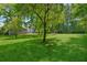 A sprawling backyard with mature trees offers shade and a picturesque setting for outdoor enjoyment at 1382 6Th Ave, Auburn, GA 30011