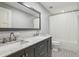 Modern bathroom with double sinks, marble countertop, and black and white tiled floors at 1382 6Th Ave, Auburn, GA 30011