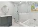 Bathroom featuring a glass-enclosed shower, soaking tub, vanity, and white subway tile at 1382 6Th Ave, Auburn, GA 30011