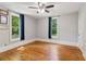 Bright bedroom with hardwood floors, natural light, and blue curtains at 1382 6Th Ave, Auburn, GA 30011