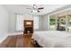 Sunlit bedroom with hardwood floors, fireplace, and large window overlooking front porch swing at 1382 6Th Ave, Auburn, GA 30011