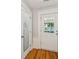Bright entryway featuring wood floors, a front door with glass panes and a pantry at 1382 6Th Ave, Auburn, GA 30011