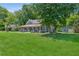 Spacious lawn and mature trees surrounding this charming home with a covered front porch, offering a serene outdoor setting at 1382 6Th Ave, Auburn, GA 30011