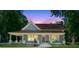 Charming blue home with a covered front porch and a beautiful dusk sky in the background at 1382 6Th Ave, Auburn, GA 30011