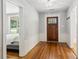 Foyer featuring hardwood floors, wooden door with glass, and white walls with wood trim at 1382 6Th Ave, Auburn, GA 30011