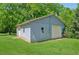 A detached garage with a single-car door and traditional siding provides ample storage and parking at 1382 6Th Ave, Auburn, GA 30011