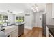 Open kitchen with island sink, granite countertops and view of front yard at 1382 6Th Ave, Auburn, GA 30011