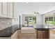 Open kitchen with island, stainless steel dishwasher, granite countertops and view of front yard at 1382 6Th Ave, Auburn, GA 30011