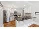 Well-lit kitchen with stainless steel refrigerator, dark countertops, and white cabinets at 1382 6Th Ave, Auburn, GA 30011