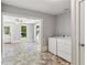 A bright laundry room adjacent to the sunroom featuring modern appliances and ample natural light at 1382 6Th Ave, Auburn, GA 30011