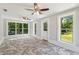 Bright living room with tile floors, two ceiling fans, and large windows overlooking the backyard at 1382 6Th Ave, Auburn, GA 30011