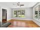 Bright living room with hardwood floors, ceiling fan, and large windows overlooking the front yard at 1382 6Th Ave, Auburn, GA 30011