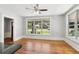 Bright living room with hardwood floors, a ceiling fan, and large windows offering plenty of natural light at 1382 6Th Ave, Auburn, GA 30011