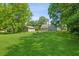 A charming home with a detached garage, surrounded by lush greenery and a well-maintained lawn at 1382 6Th Ave, Auburn, GA 30011