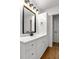 Modern bathroom vanity with sleek black accents, featuring ample cabinet space and laminate flooring for a clean look at 1603 Cumberland Ct, Smyrna, GA 30080