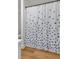 Charming bathroom with blue floral curtain, blending elegance with privacy on top of waterproof laminate flooring at 1603 Cumberland Ct, Smyrna, GA 30080