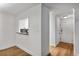 Light and airy hallway with crisp white trim and updated wood floors throughout at 1603 Cumberland Ct, Smyrna, GA 30080