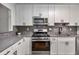 Modern kitchen boasts stainless steel appliances, gray countertops, and sleek cabinets at 1603 Cumberland Ct, Smyrna, GA 30080