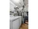 Functional laundry area featuring modern washer/dryer, shelving, and a water heater, optimizing space and efficiency at 1603 Cumberland Ct, Smyrna, GA 30080