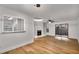 Open-concept living room boasting a fireplace, natural light, and hardwood floors at 1603 Cumberland Ct, Smyrna, GA 30080