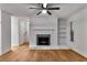 Cozy living room with a fireplace, open shelving, and warm hardwood floors at 1603 Cumberland Ct, Smyrna, GA 30080