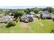 A brick home with a walkout basement sits on a large lot with mature trees, surrounded by other upscale homes at 411 Hickory Fairway Ct, Woodstock, GA 30188