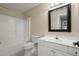 Bathroom with white vanity, toilet, and shower-tub combo at 411 Hickory Fairway Ct, Woodstock, GA 30188