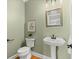 Well-maintained half bathroom featuring a stylish pedestal sink, modern fixtures, and a clean design at 411 Hickory Fairway Ct, Woodstock, GA 30188