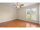 Bedroom with light hardwood floors, bright windows and ceiling fan at 411 Hickory Fairway Ct, Woodstock, GA 30188
