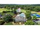 Community center featuring a pool, tennis courts, clubhouse, and golf course amidst mature trees at 411 Hickory Fairway Ct, Woodstock, GA 30188