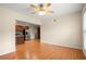 Dining area showcasing hardwood floors and an open concept design, with a glimpse into the adjacent kitchen at 411 Hickory Fairway Ct, Woodstock, GA 30188