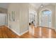 Bright and airy foyer with hardwood floors and a transom window above the front door at 411 Hickory Fairway Ct, Woodstock, GA 30188