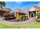 Beautiful brick home with manicured landscaping and a curved sidewalk to the front door at 411 Hickory Fairway Ct, Woodstock, GA 30188