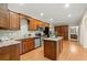 Well-equipped kitchen with stainless steel appliances, wooden cabinets, granite countertops, and hardwood floors at 411 Hickory Fairway Ct, Woodstock, GA 30188