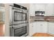 Modern kitchen with stainless steel ovens and ample counter space, perfect for cooking and baking at 411 Hickory Fairway Ct, Woodstock, GA 30188