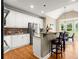 Stylish kitchen with stainless steel appliances, granite countertops, and a breakfast bar perfect for casual dining and entertaining at 411 Hickory Fairway Ct, Woodstock, GA 30188