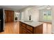 Bright kitchen with island, granite countertops, and wood cabinets at 411 Hickory Fairway Ct, Woodstock, GA 30188