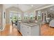 Open concept kitchen with granite countertops, stainless steel appliances, and hardwood floors, perfect for cooking and entertaining at 411 Hickory Fairway Ct, Woodstock, GA 30188