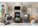 Cozy living room with a fireplace, built-in bookshelves, and comfortable seating for relaxing with friends and Gathering at 411 Hickory Fairway Ct, Woodstock, GA 30188