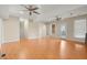 Spacious living room with hardwood floors, neutral paint, staircase, multiple windows, and french doors at 411 Hickory Fairway Ct, Woodstock, GA 30188