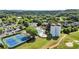 Aerial view of a community pool with a waterslide, surrounded by tennis courts and a golf course at 411 Hickory Fairway Ct, Woodstock, GA 30188