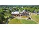 Aerial view of a rustic-style restaurant, golf course, and well-manicured landscaping in a golf community at 411 Hickory Fairway Ct, Woodstock, GA 30188