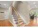 Open staircase with hardwood steps and an iron railing at 411 Hickory Fairway Ct, Woodstock, GA 30188