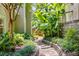 Stone pathway meanders through landscaped backyard with tropical foliage, creating a garden oasis at 1078 Shady Valley Ne Pl, Atlanta, GA 30324