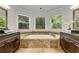 Bathroom featuring a soaking tub with large windows and granite countertops at 1078 Shady Valley Ne Pl, Atlanta, GA 30324