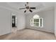 Bright bedroom features a ceiling fan, plush carpet and a large window, creating a welcoming space at 1078 Shady Valley Ne Pl, Atlanta, GA 30324