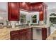 Updated kitchen with granite counters, stainless steel appliances, custom cabinets, and tile backsplash at 1078 Shady Valley Ne Pl, Atlanta, GA 30324