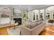 Sunlit living room with a fireplace, hardwood floors, and neutral decor at 1078 Shady Valley Ne Pl, Atlanta, GA 30324