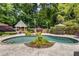 Inviting backyard features a private pool, gazebo, and a sitting area surrounded by trees at 1078 Shady Valley Ne Pl, Atlanta, GA 30324